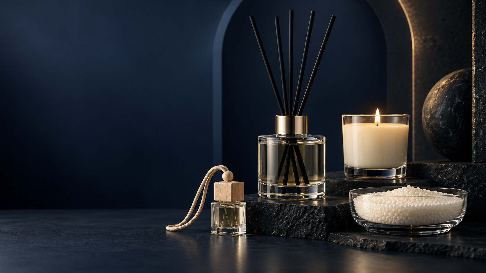 Reed diffuser, hanging car fragrance, candle and pearl wax arranged in a premium studio setting